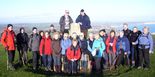 Walkers at 
the Trig Point on Shanklin Down, Isle of Wight